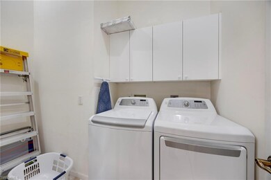 Laundry room featuring separate washer and dryer and cabinet space