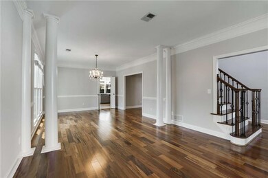Unfurnished dining area with decorative columns, d