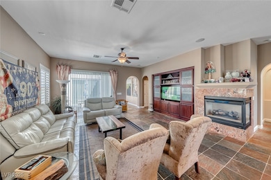 Living area with arched walkways, visible vents, b