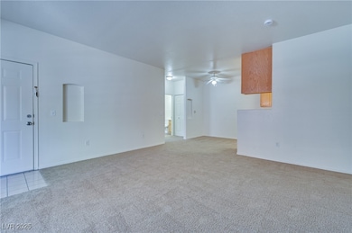 Unfurnished living room featuring light colored ca