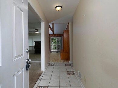 Hallway featuring baseboards and light tile patterned floors