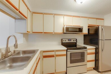 Galley kitchen with resurfaced countertops and all
