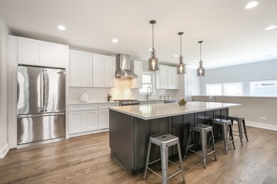 White shaker cabinets with dark island. Enormous 1