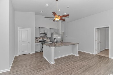 Kitchen featuring light stone countertops, stainle