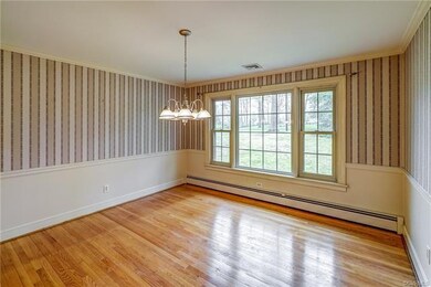 Dining room has hw floors, crown and chairrail