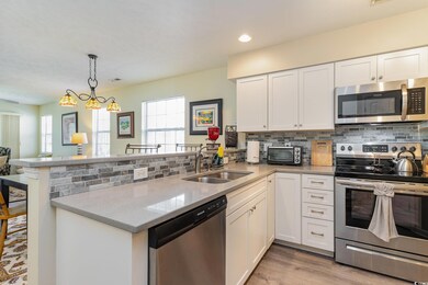 Kitchen with backsplash, a peninsula, stainless st