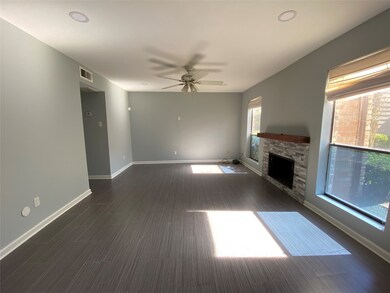 Spaced living room with large window and ceiling f