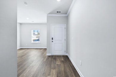 Interior space with ornamental molding and dark wo