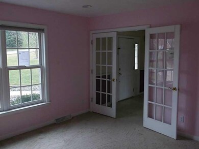 Den. Den off the main entry with french doors.