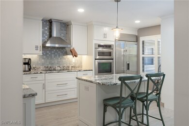 Kitchen featuring decorative light fixtures, wall