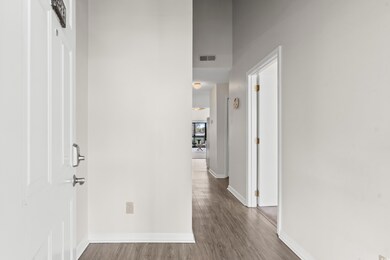Corridor with hardwood / wood-style flooring