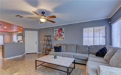Living area featuring visible vents, crown molding
