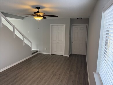 Unfurnished living room featuring ceiling fan and