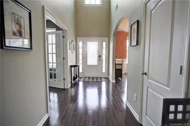 Grand foyer with 2 story ceilings and gleaming har