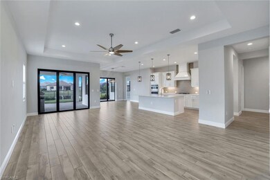 Unfurnished living room featuring ceiling fan, a t
