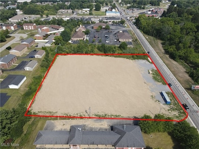 Aerial view of property and surrounding area featuring property parcel outlined
