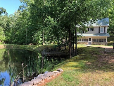 Cottage  view across the dam of the pond