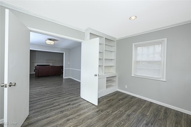 Unfurnished room featuring dark wood-style flooring, recessed lighting, and crown molding