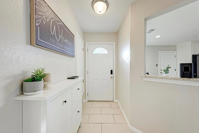 Doorway to outside featuring light tile patterned