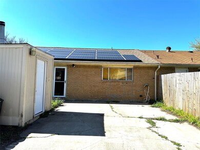 Rear view of house with brick siding, roof mounted