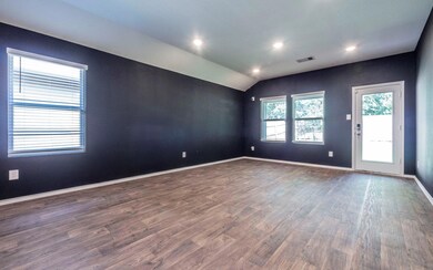 Spare room with dark wood-style floors, lofted ce