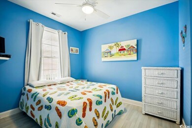 Bedroom with visible vents, ceiling fan, light wood-style flooring, and baseboards