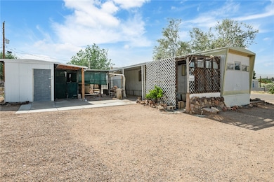 Back of property with an outdoor structure