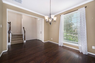 Formal dining room just off the front entry features gorgeous hardwood flooring and crown molding.