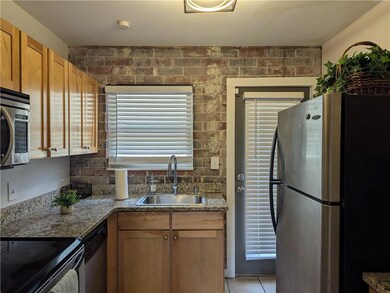 Kitchen with light tile patterned floors, stainles