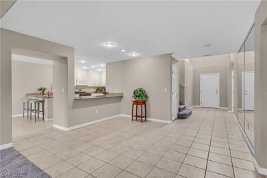 Entryway and kitchen with neutral paint and tile f