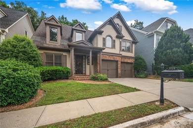View of front of home featuring driveway, roof with shingles, a front lawn, a garage, and brick siding