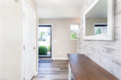 beautiful foyer w/luxury vinyl flooring & custom shiplap wall