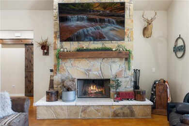 Room details featuring a fireplace and baseboards