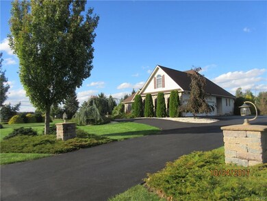View from the street of the circular drive and 3 c