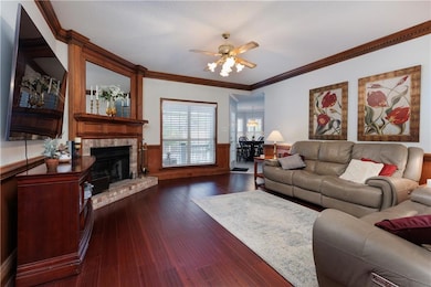 Living area featuring a wainscoted wall, ornamenta
