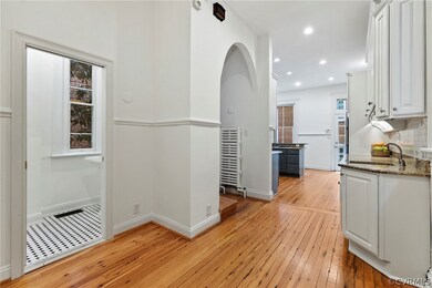 Kitchen entry w/ rear staircase & basement access