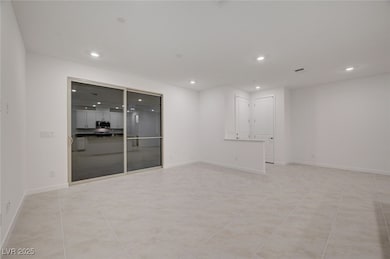 Spare room with recessed lighting and baseboards