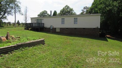Back of home has deck to enjoy tons of privacy.