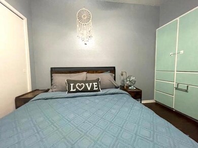 Bedroom with dark wood finished floors
