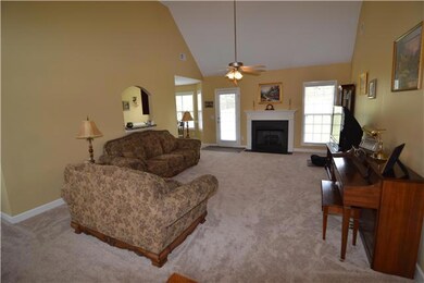 Living room has soaring ceilings and gas fireplace