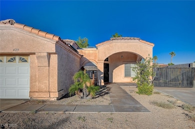 Mediterranean / spanish house featuring stucco siding, a tile roof, and a garage