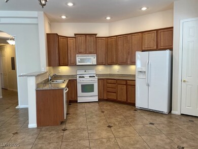 Kitchen featuring white appliances, recessed light