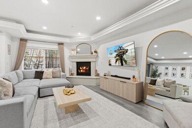 Living room with luxury vinyl flooring, recessed lighting, fireplace - lights and blinds operate on voice command.