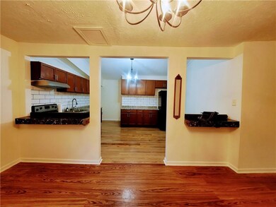 Kitchen featuring a sink, under cabinet range hood