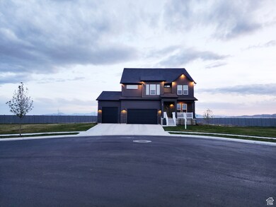 View of front of house with driveway and an attached garage