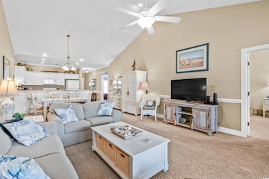 Living room with light carpet, ceiling fan, recessed lighting, and vaulted ceiling