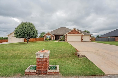 View of front facade featuring roof with shingles, driveway, brick siding, and a garage