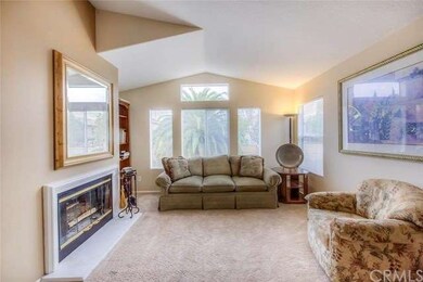 Living room features wood-burning fireplace and pl