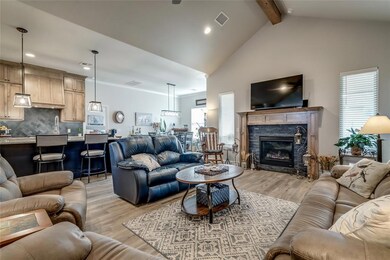 Living room featuring beamed ceiling, high vaulted