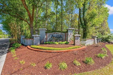 Community / neighborhood sign featuring fence